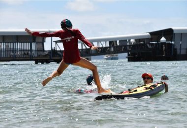 Nipper jumping onto rescue board in the water